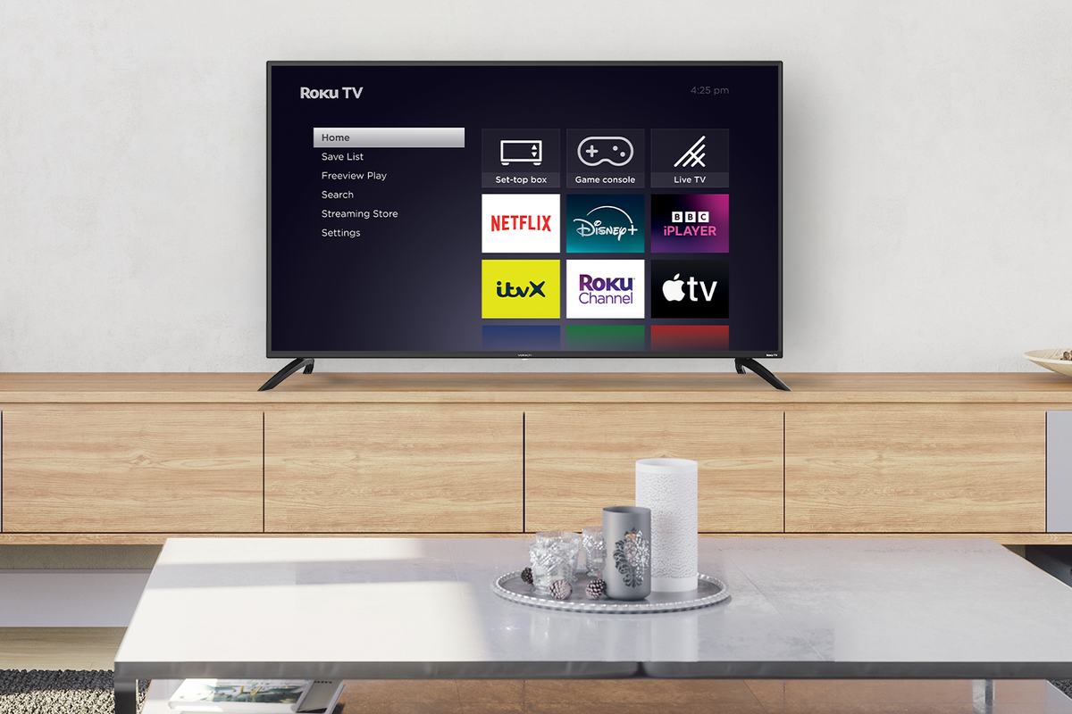 roku smart tv on a sideboard with candles on a small table