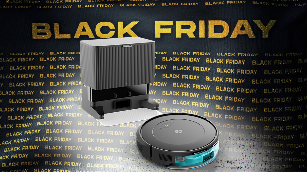 roomba vacuum cleaner leaving its charging station with a black friday banner in the background