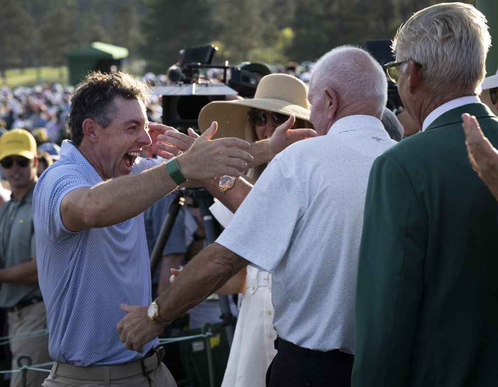 Rory McIlroy embraced his father after making history at the Masters