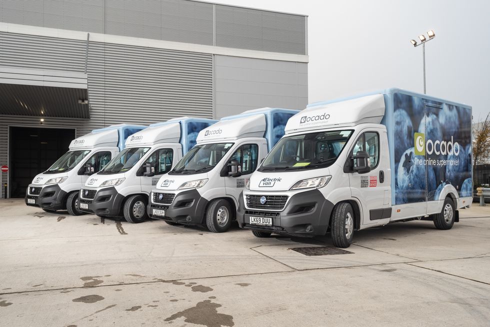 Row of electric vans parked