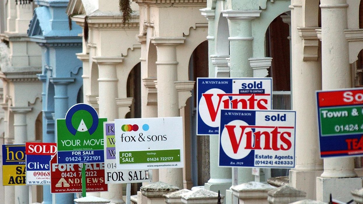Row of for sale and sold signs