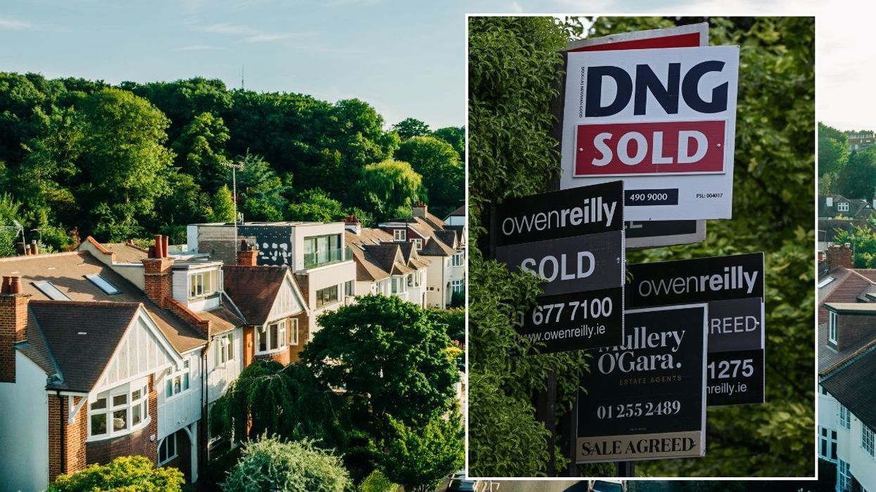 row of houses and sale signs