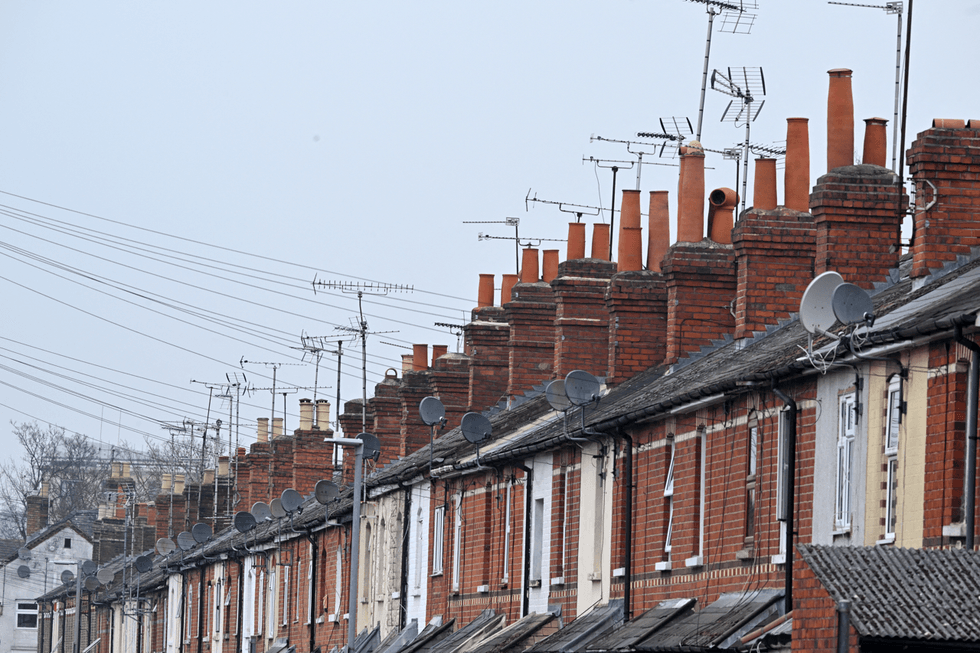 row of terrace houses in the UK with television aerials shown on roofs