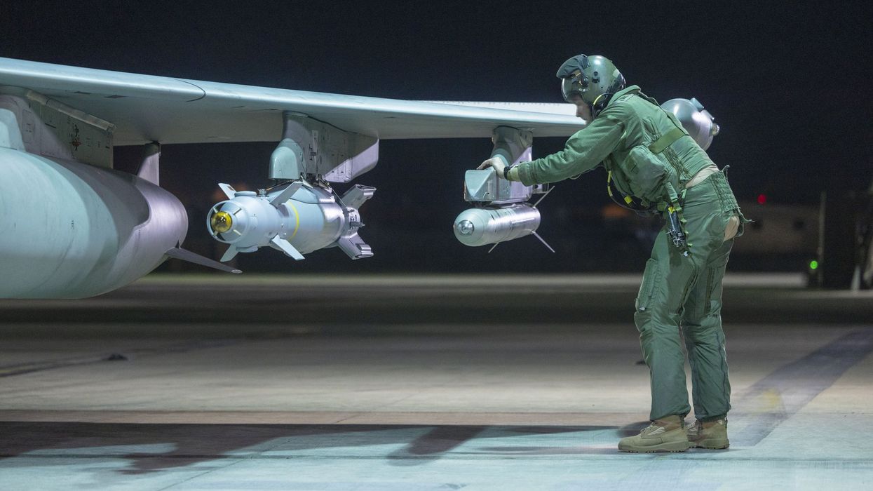 Royal Air Force Typhoon pilot examines jet's munitions