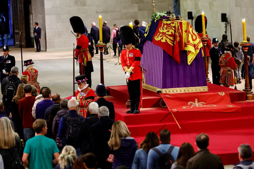 Royal guards stand by the coffin of Britain's Queen Elizabeth as members of the public pay their respects, following her death, during her lying-in-state at Westminster Hall, in London, Britain, September 18, 2022. REUTERS/Sarah Meyssonnier/Pool