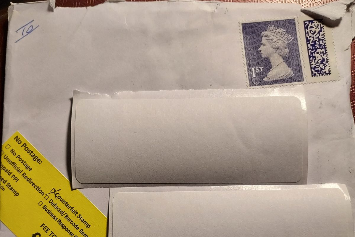 Royal Mail 'counterfeit stamp' sign on letter and first class barcoded stamp on envelope