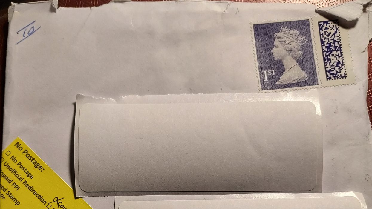 Royal Mail 'counterfeit stamp' sign on letter and first class barcoded stamp on envelope