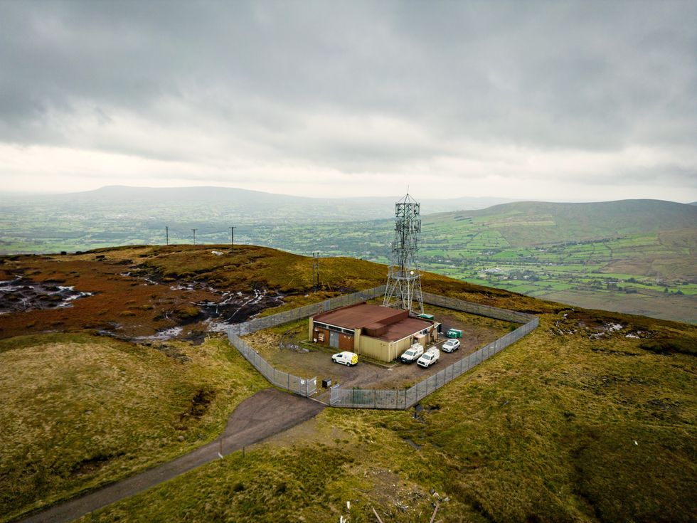 rural mast pictured on top of a hill in the UK