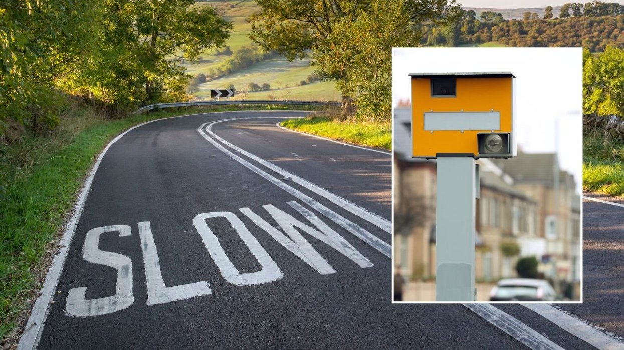 Rural road with 'slow' painted and a speed camera