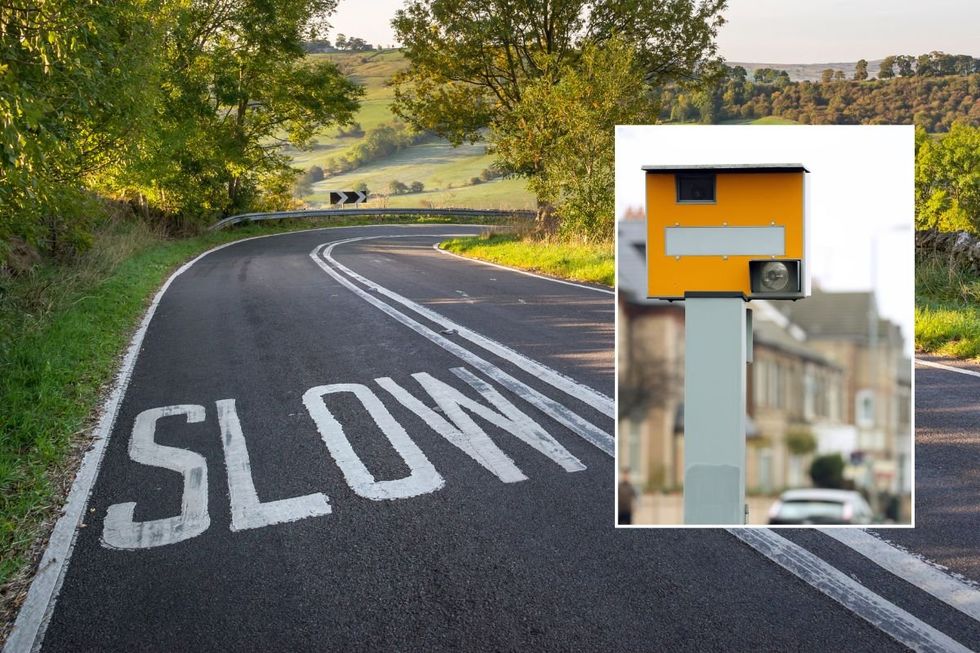 Rural road with 'slow' painted and a speed camera