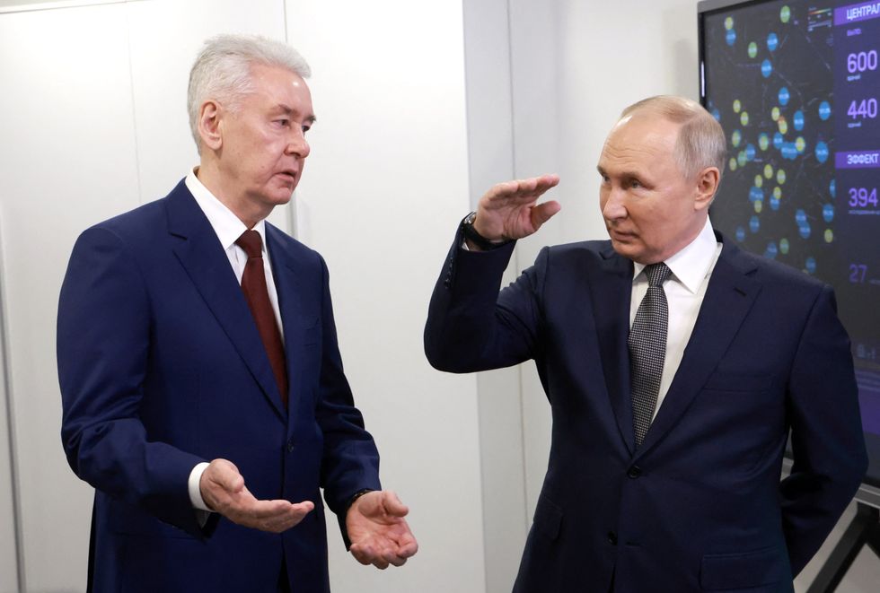 Russia's President Vladimir Putin, accompanied by Moscow Mayor Sergei Sobyanin
