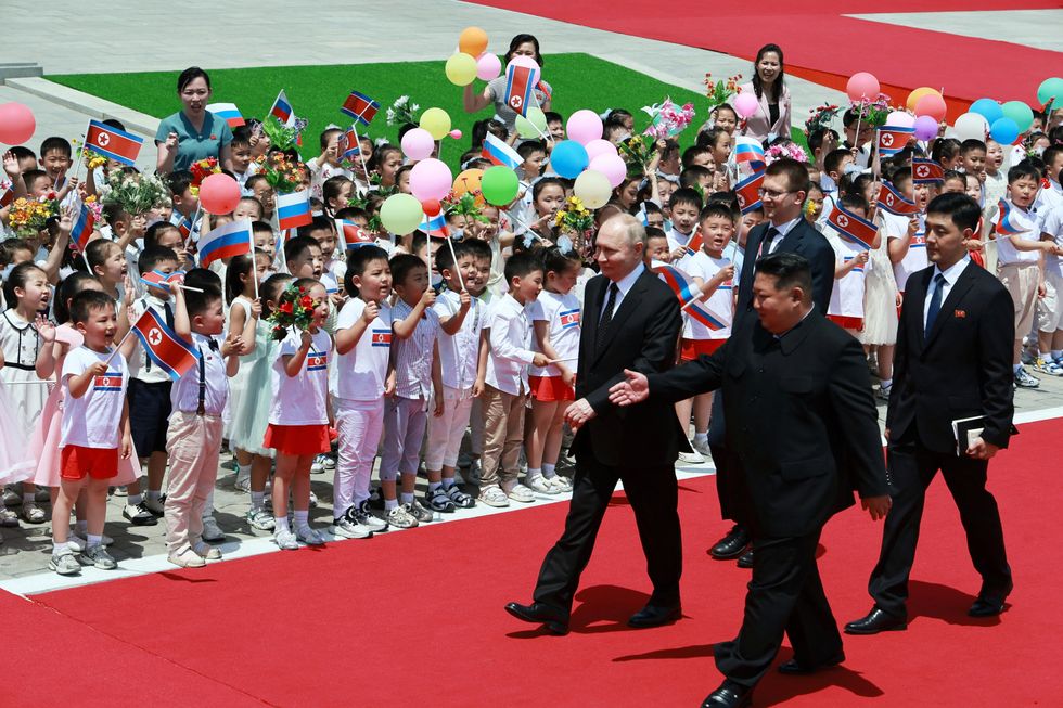 Russia's President Vladimir Putin and North Korea's leader Kim Jong Un attend an official welcoming ceremony