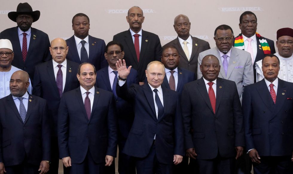 Russia's President Vladimir Putin waves during a family photo with heads of countries taking part in the 2019 Russia-Africa Summit at the Sirius Park of Science and Art in Sochi