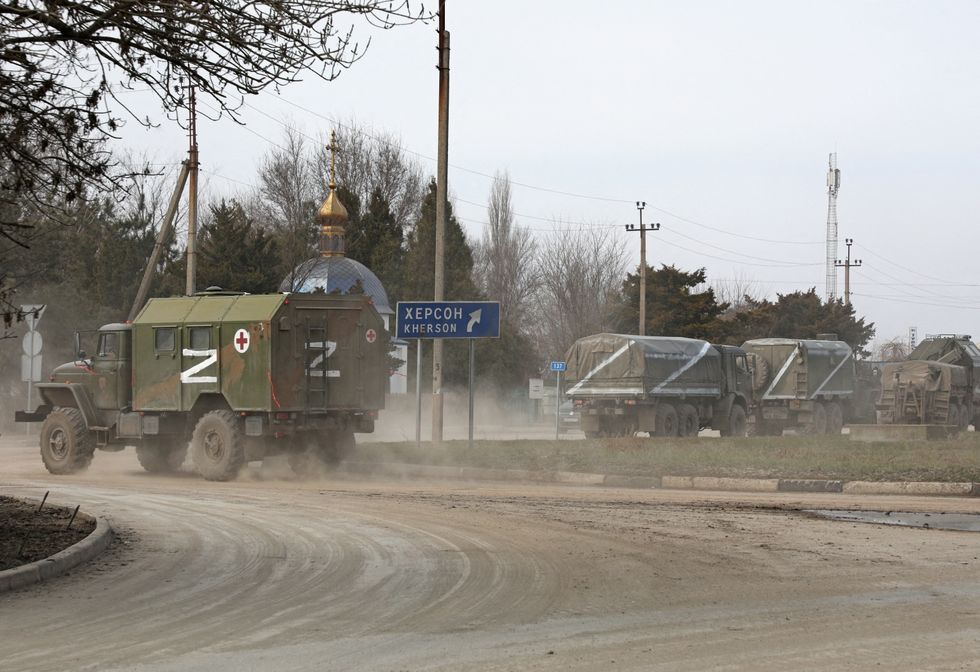 Russian Army military vehicles with the letter 'Z' on them drive along a street, after Russian President Vladimir Putin authorised a military operation in eastern Ukraine, in the town of Armyansk, Crimea, February 24, 2022. REUTERS/Stringer