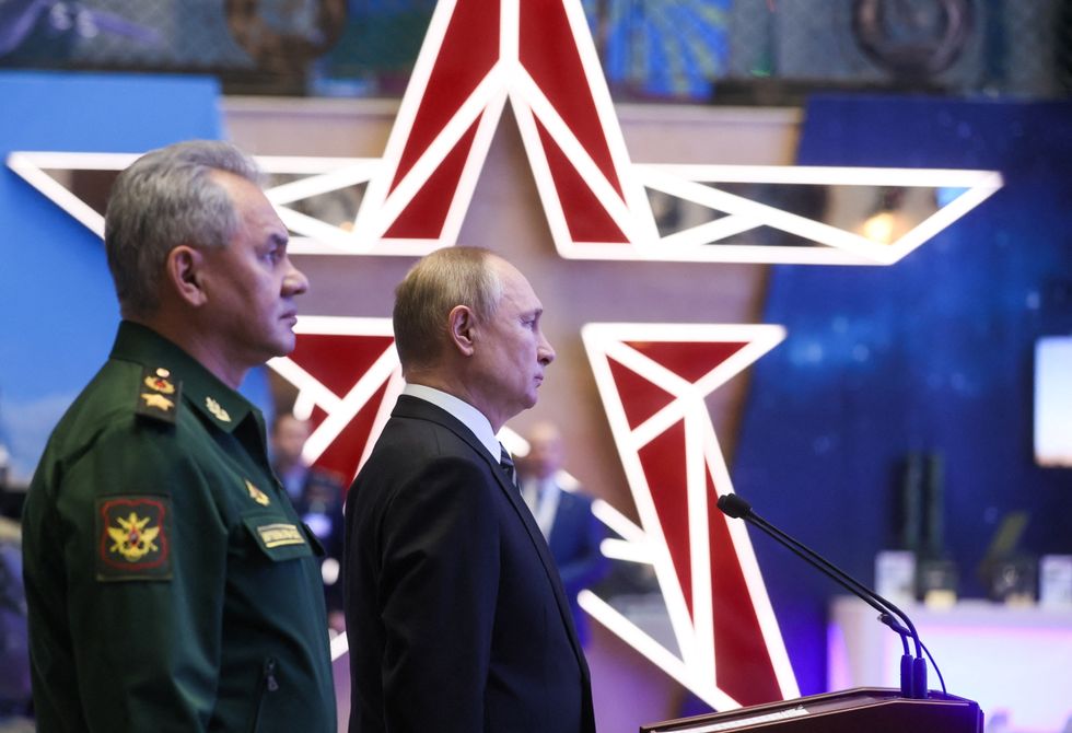 Russian President Vladimir Putin and Defence Minister Sergei Shoigu attend a military exhibition before an expanded meeting of the Defence Ministry Board in Moscow.