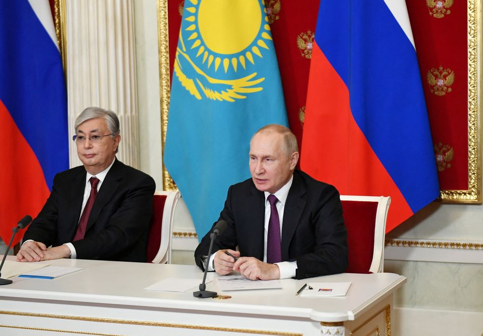 Russian President Vladimir Putin and Kazakh President Kassym-Jomart Tokayev address the participants of a session of the Russia-Kazakhstan Interregional Cooperation Forum via a video link in Moscow, Russia November 28, 2022. Sputnik/Mikhail Klimentyev/Kremlin via REUTERS ATTENTION EDITORS - THIS IMAGE WAS PROVIDED BY A THIRD PARTY.