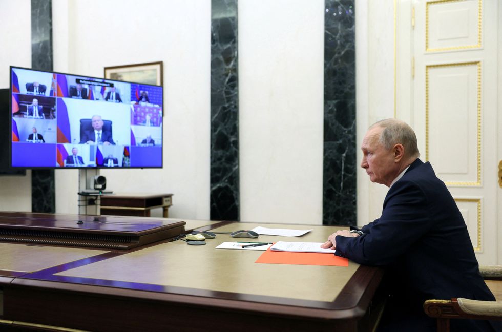 Russian President Vladimir Putin chairs a meeting with members of the Security Council via a video link in Moscow