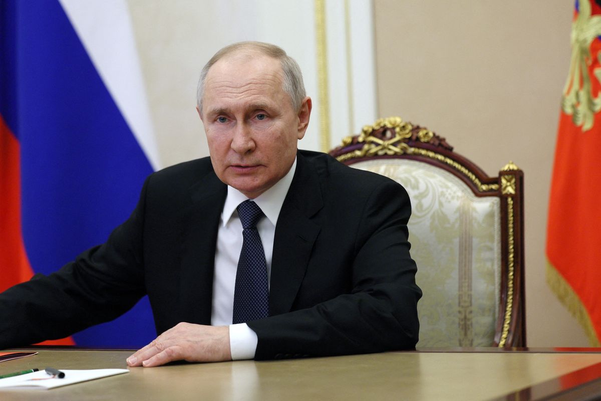 Russian President Vladimir Putin chairs a meeting with members of the Security Council