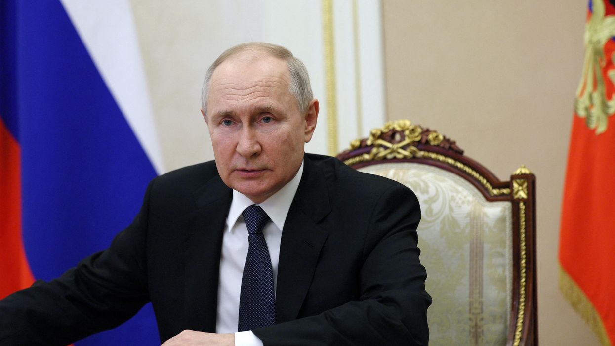 Russian President Vladimir Putin chairs a meeting with members of the Security Council