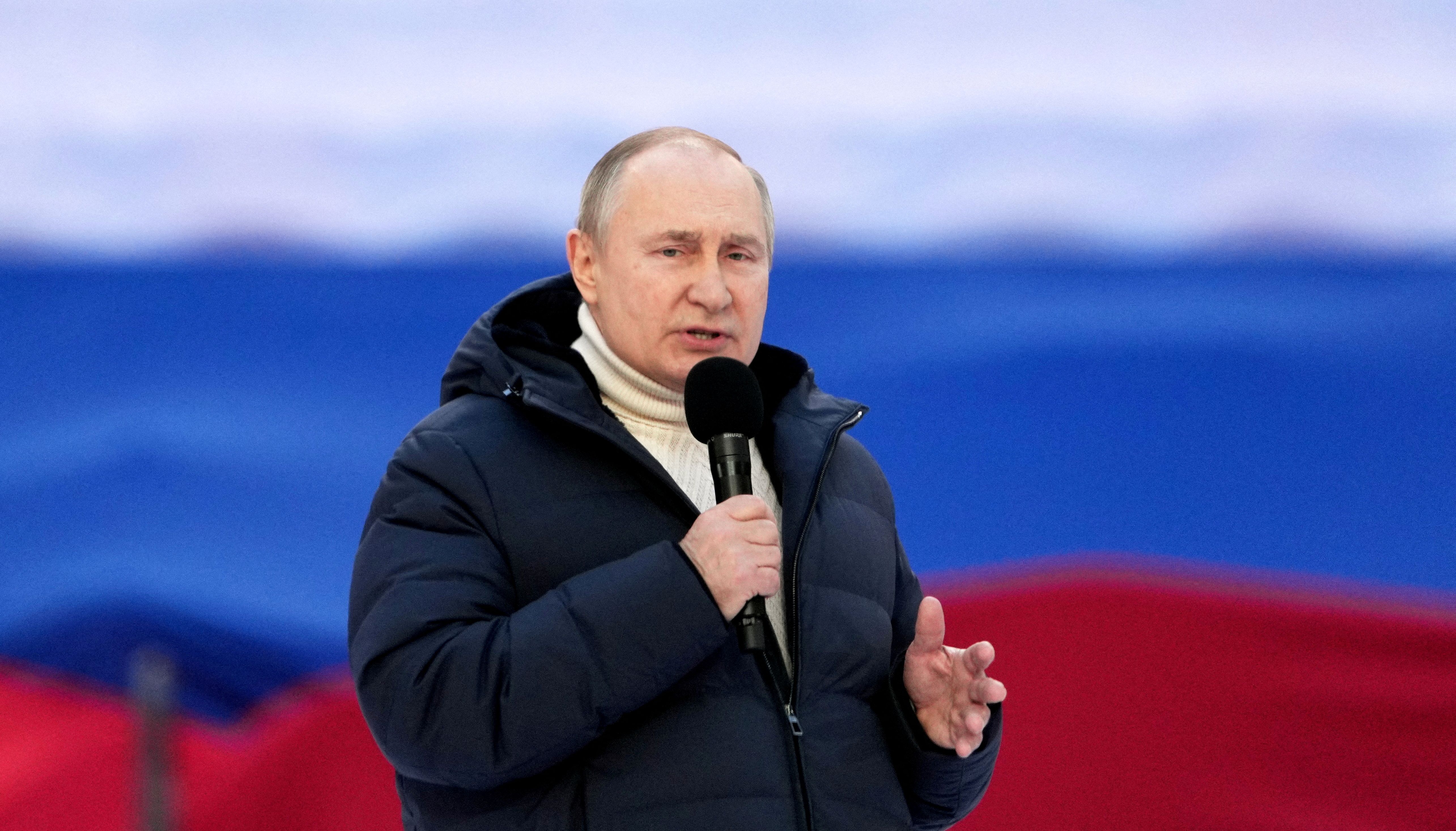 Russian President Vladimir Putin delivers a speech during a concert marking the eighth anniversary of Russia's annexation of Crimea at Luzhniki Stadium in Moscow