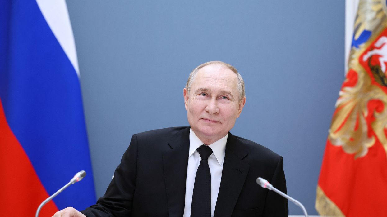 Russian President Vladimir Putin holds a meeting with large families from various Russia's regions via video link at the Kremlin in Moscow