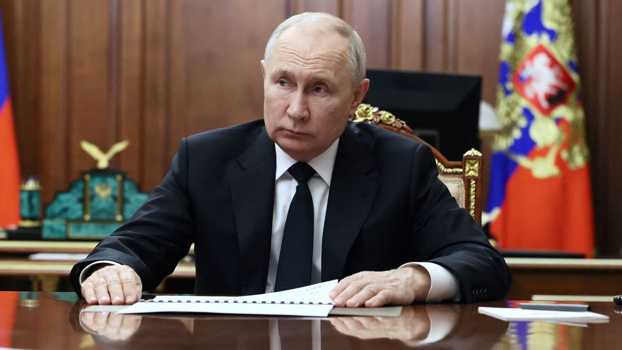 Russian President Vladimir Putin listens to Deputy Prime Minister and Minister of Industry and Trade Denis Manturov during a meeting at the Kremlin in Moscow