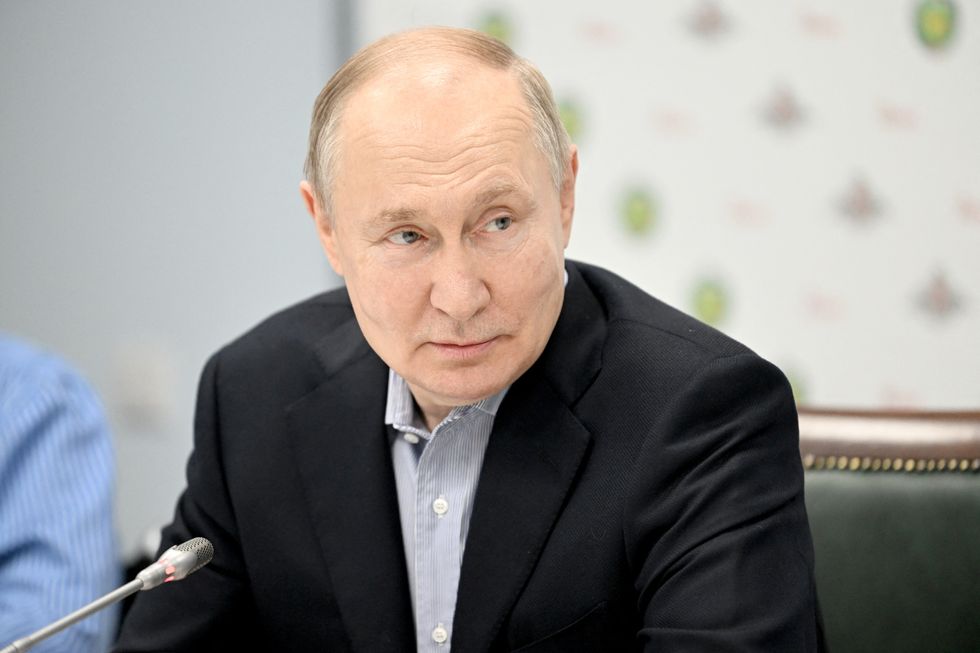 Russian President Vladimir Putin meets with service members