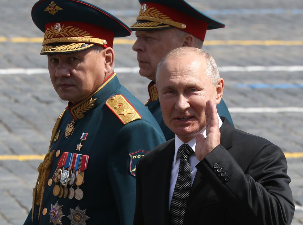 Russian President Vladimir Putin (R), Sergei Shoigu (L) and Oleg Salyukov (C)