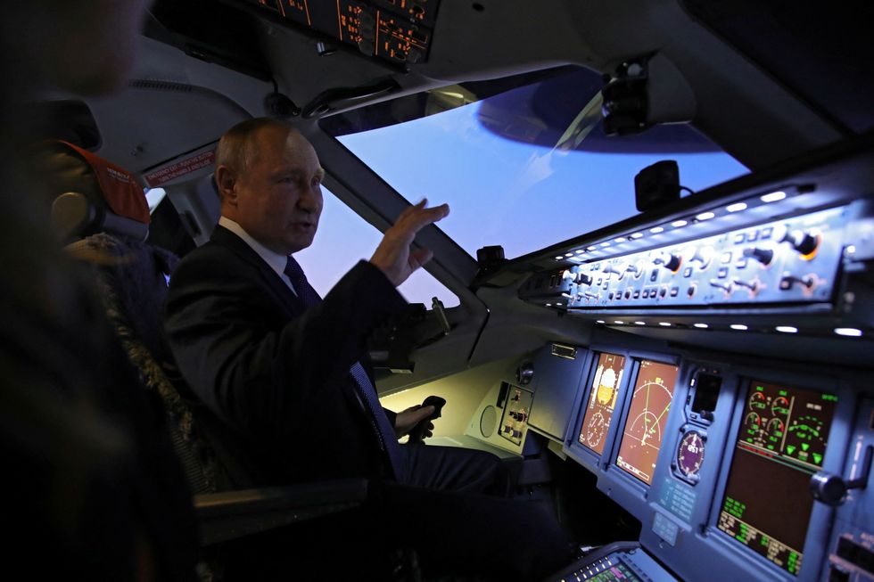 Russian President Vladimir Putin sits in a training simulator as he visits the Aeroflot Aviation School on the suburbs of Moscow, Russia