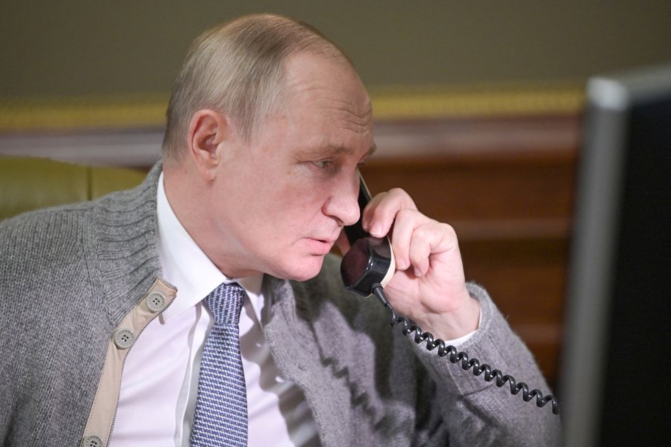 Russian President Vladimir Putin speaks on the phone during a conversation with a participant of a Christmas charity event in Strelna on the outskirts of Saint Petersburg, Russia December 27, 2021. Sputnik/Aleksey Nikolskyi/Kremlin via REUTERS ATTENTION EDITORS - THIS IMAGE WAS PROVIDED BY A THIRD PARTY.