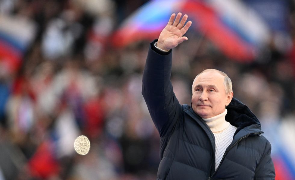Russian President Vladimir Putin waves during a concert marking the eighth anniversary of Russia's annexation of Crimea at Luzhniki Stadium in Moscow, Russia March 18, 2022. Sputnik/Ramil Sitdikov/Kremlin via REUTERS ATTENTION EDITORS - THIS IMAGE WAS PROVIDED BY A THIRD PARTY.