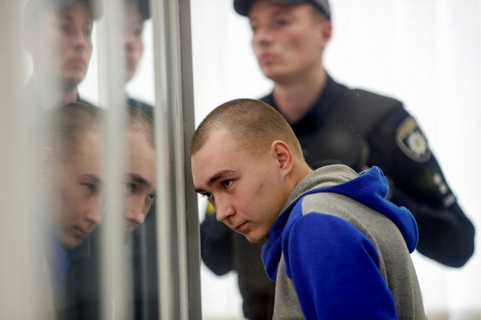 Russian soldier Vadim Shishimarin, 21, suspected of violations of the laws and norms of war, sits inside a cage during a court hearing, amid Russia's invasion of Ukraine, in Kyiv, Ukraine May 23, 2022. REUTERS/Viacheslav Ratynskyi