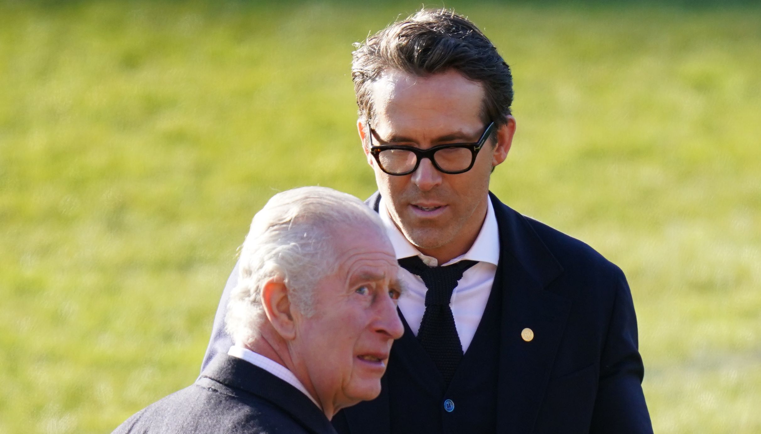 Ryan Reynolds talks with King Charles III at Wrexham Association Football Club's Racecourse Ground. The King and Queen Consort will meet with owners and Hollywood actors, Ryan Reynolds and Rob McElhenney, and players to learn about the redevelopment of the club, as part of their visit to Wrexham. Picture date: Friday December 9, 2022.