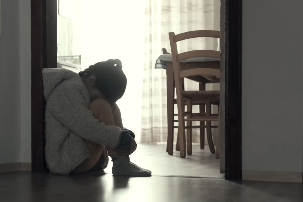 Sad child sitting on the floor