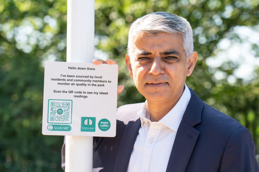 Sadiq Khan with an air quality sign