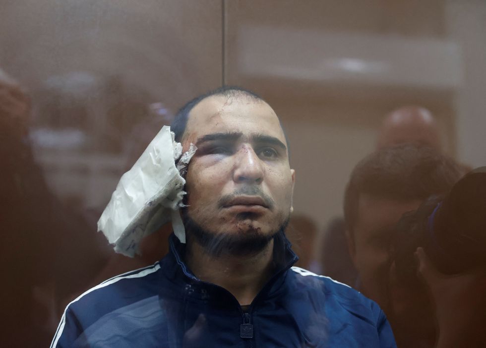 Saidakrami Murodali Rachabalizoda, a suspect in the shooting attack at the Crocus City Hall concert venue, sits behind a glass wall