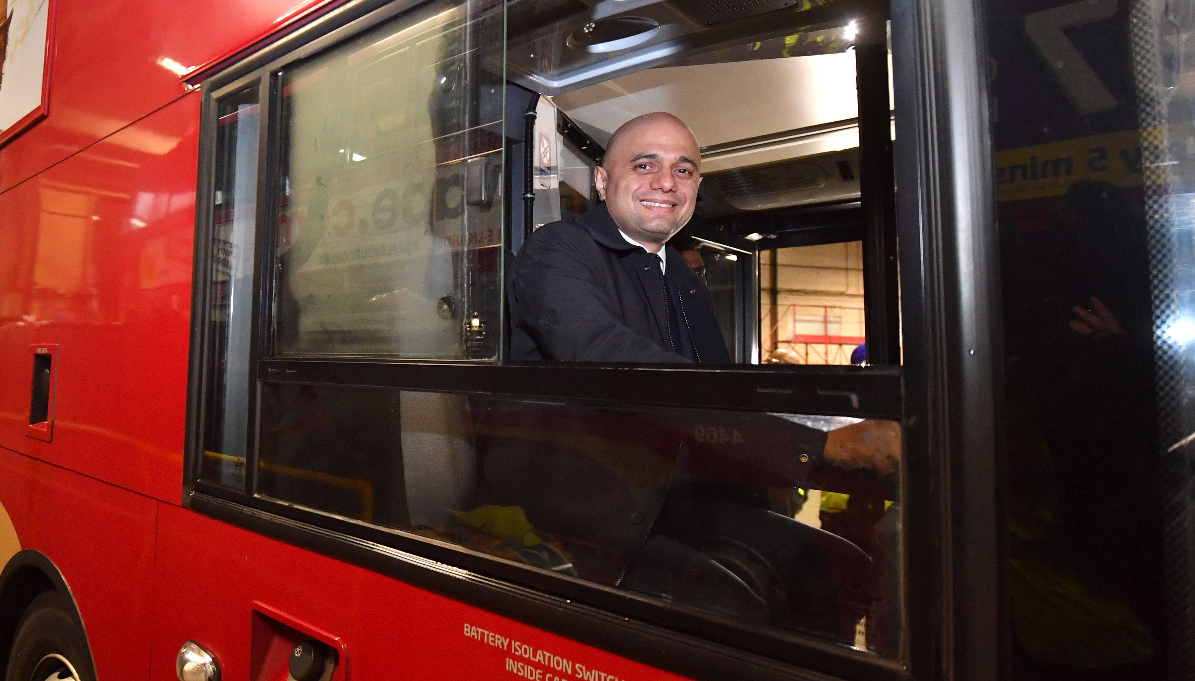 Sajid Javid, sitting in the driver's seat of a bus during a visit to Birmingham Central Bus Garage.