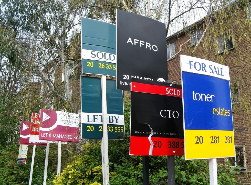 Sale signs outside house