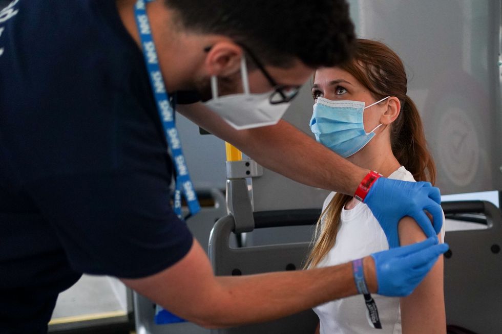 Sami Stebbings receives a dose of a Covid-19 vaccine on board a vaccination bus at the Latitude festival in Henham Park, Southwold, Suffolk. Picture date: Friday July 23, 2021.