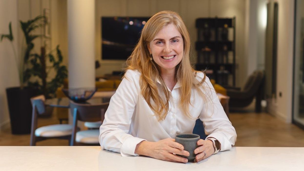 Samsung Chief Customer Officer Deborah Honig sits at a desk with a mug