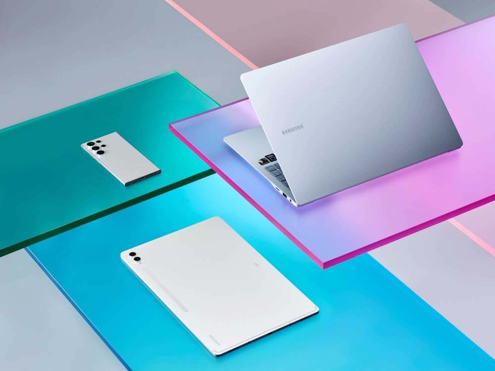 samsung galaxy book 4 edge pictured on colourful ledges beside other samsung devices like the s24 and tab s9 tablet