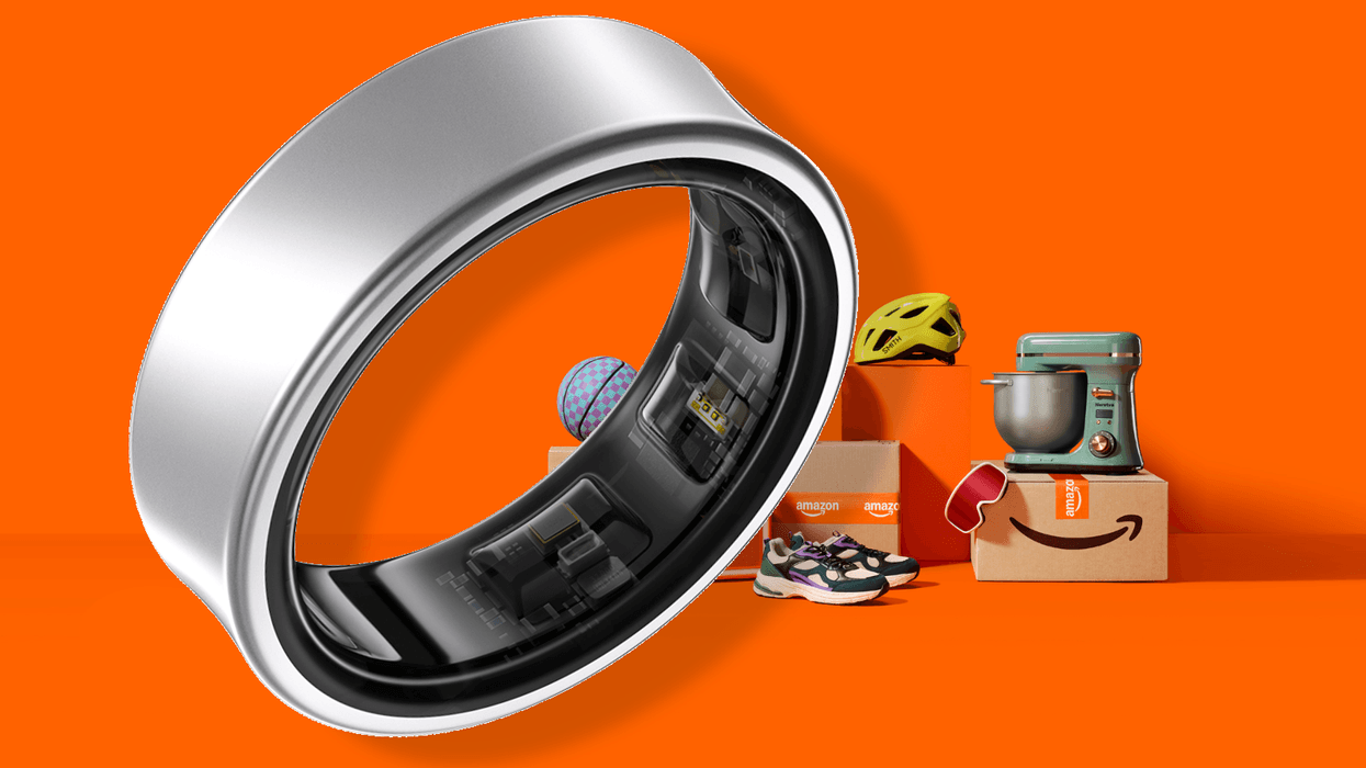 Samsung Galaxy Ring in front of Amazon boxes and orange background