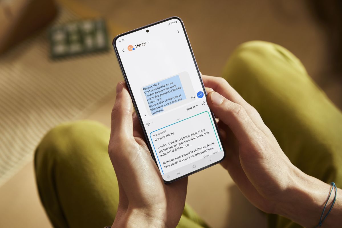 samsung galaxy s24 phone pictured in someones hands with a realtime translation of a text message