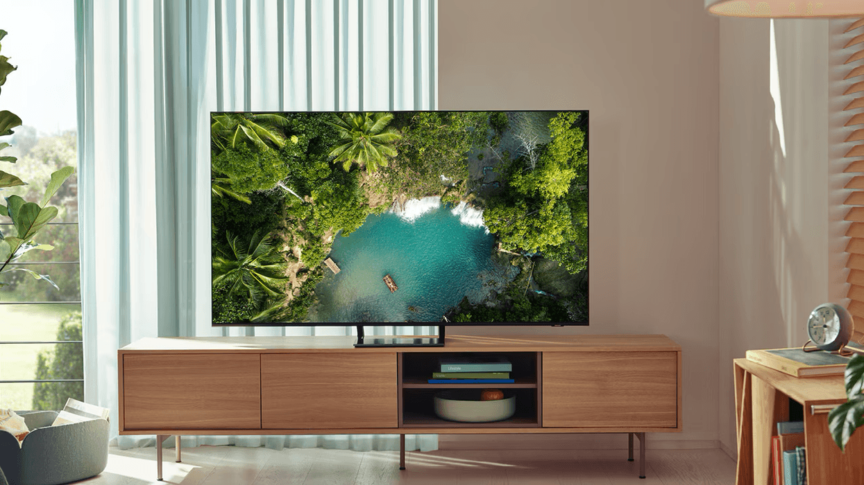 samsung qled tv pictured on a media unit in a living room
