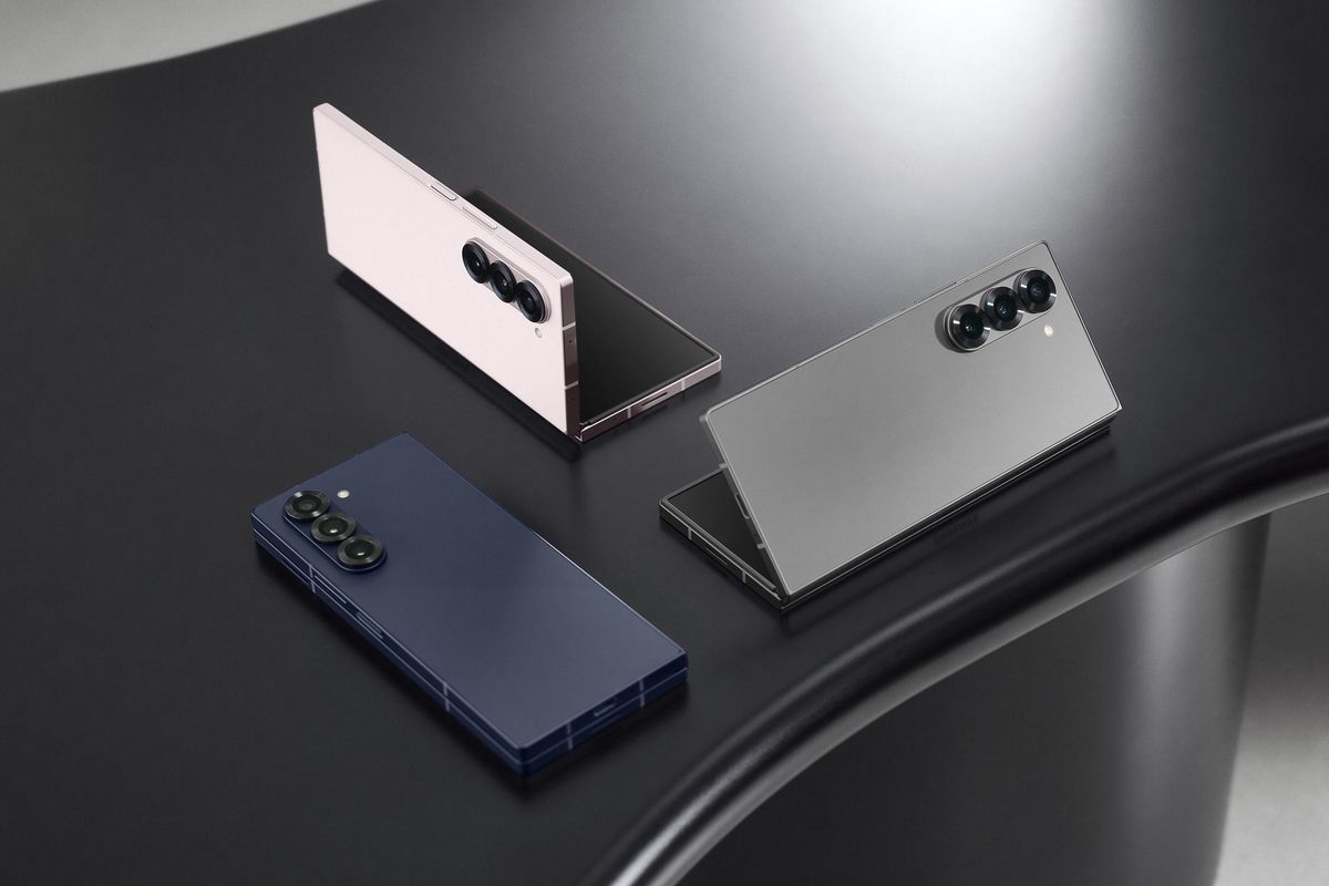 samsung \u200bGalaxy Z Fold 6 in Silver Shadow, Pink, and Navy pictured on a black table