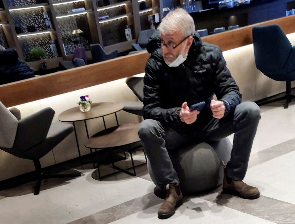 Sanctioned Russian oligarch Roman Abramovich sits in a VIP lounge before a jet linked to him took off for Istanbul from Ben Gurion international airport in Lod near Tel Aviv, Israel, March 14, 2022. REUTERS/Stringer  ISRAEL OUT. NO COMMERCIAL OR EDITORIAL SALES IN ISRAEL