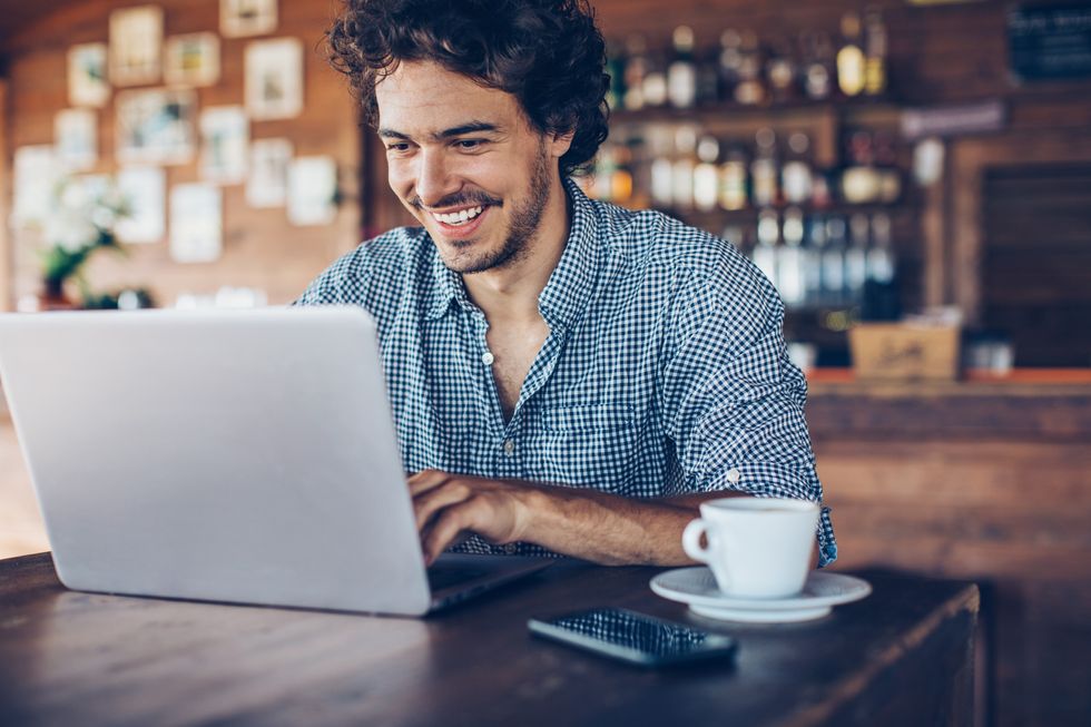 Saver looks happy at laptop