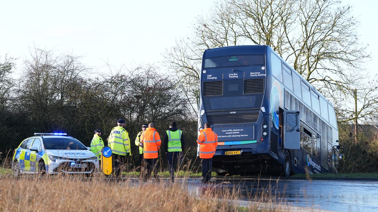 School bus full of children crashes into ditch after slipping on black ice as emergency services rush to the scene