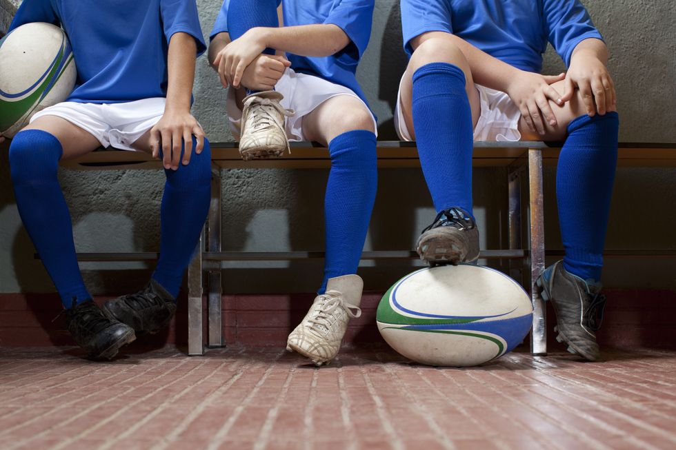 Schoolchildren with rugby balls