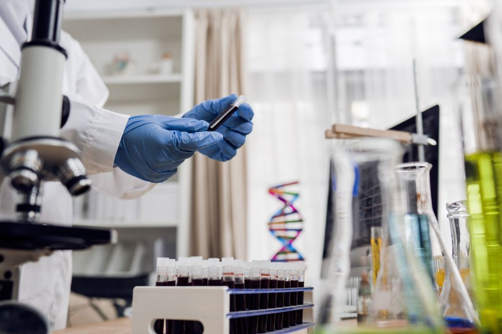 Scientist holding a vial in lab